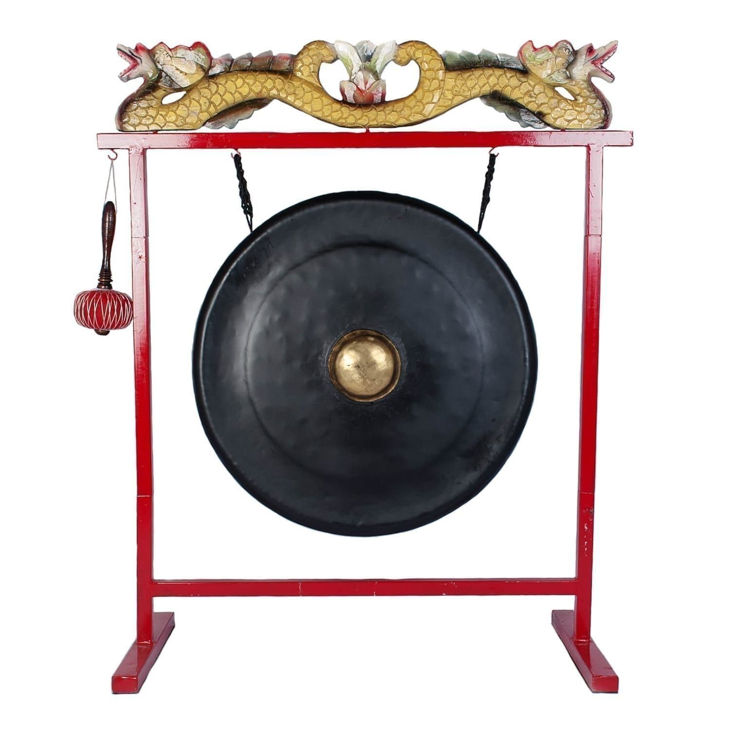 This is a product image of the Gong Set - 32in (80cm) diameter Gong with Stand and Beater. The frame is a sleek metal design, painted red with a two ornate wooden dragons in red white and gold, sitting on the crossbar. The Gong is matt black with a gold boss and is hanging evenly from two hooks. The beater is attached to a hook on the left hand side of the stand. The image has been taken from a head on position.