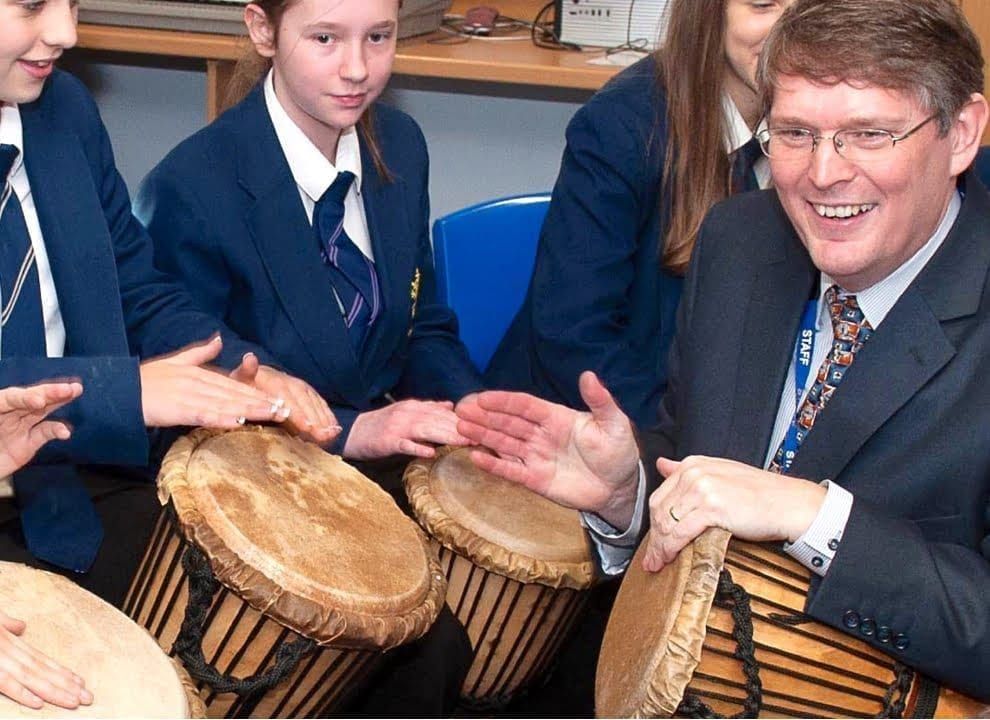 Children playing djembe drums