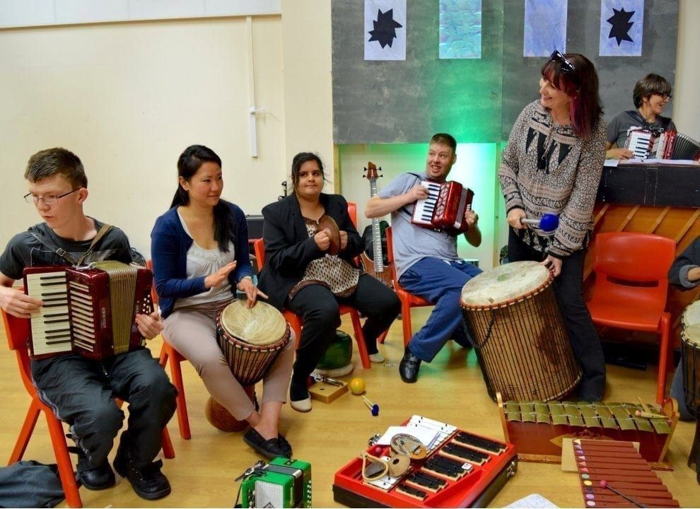 Children playing world music drums together